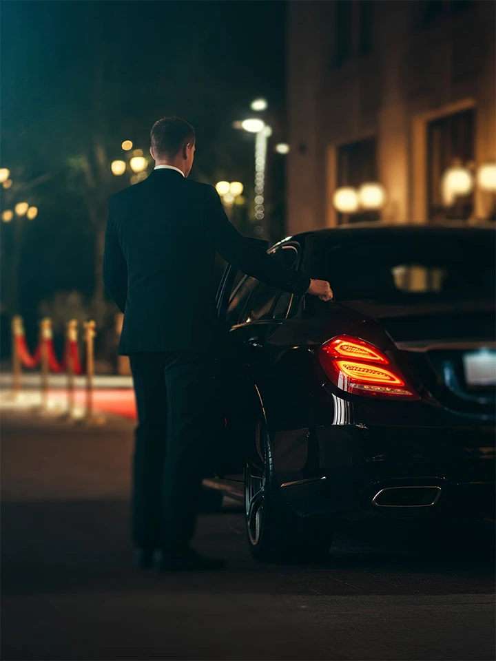 Luxury Chauffeur Service closing door for a couple on a night out